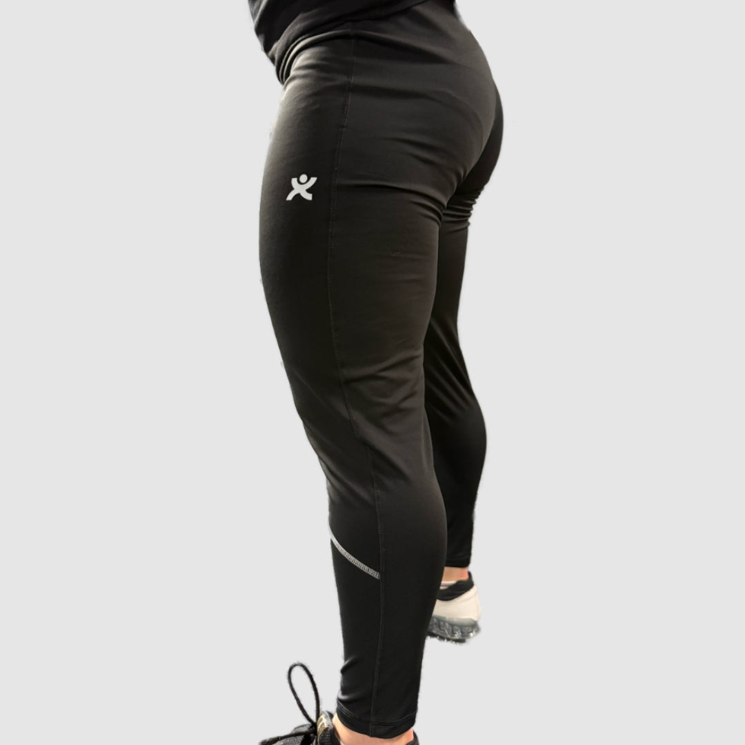 Side view of Super Weightlifting Second Pull Tights — black athletic leggings with reflective details and logo on the thigh.