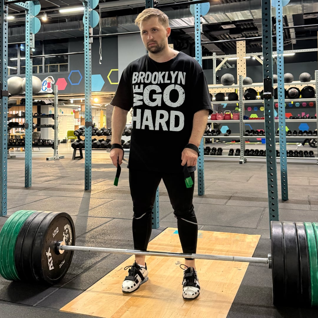 Gabriel Sincraian wearing Super Weightlifting 190 Heritage Tee while training with barbell in gym