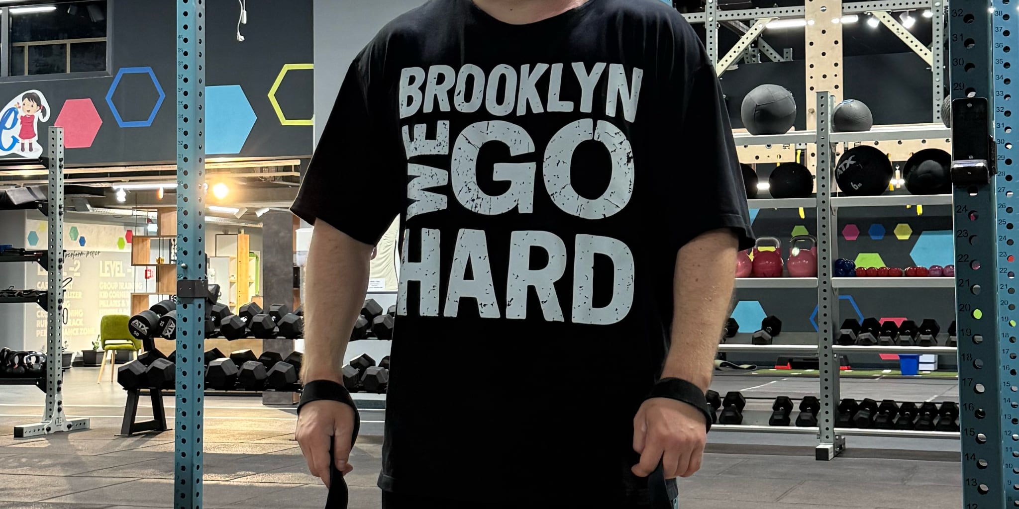 Gabriel Sincraian wearing Super Weightlifting 190 Heritage Tee while training with barbell in gym